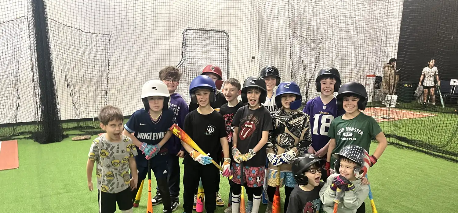 Young players with bats and helmets during a camp at the Gorilla Baseball Academy facility