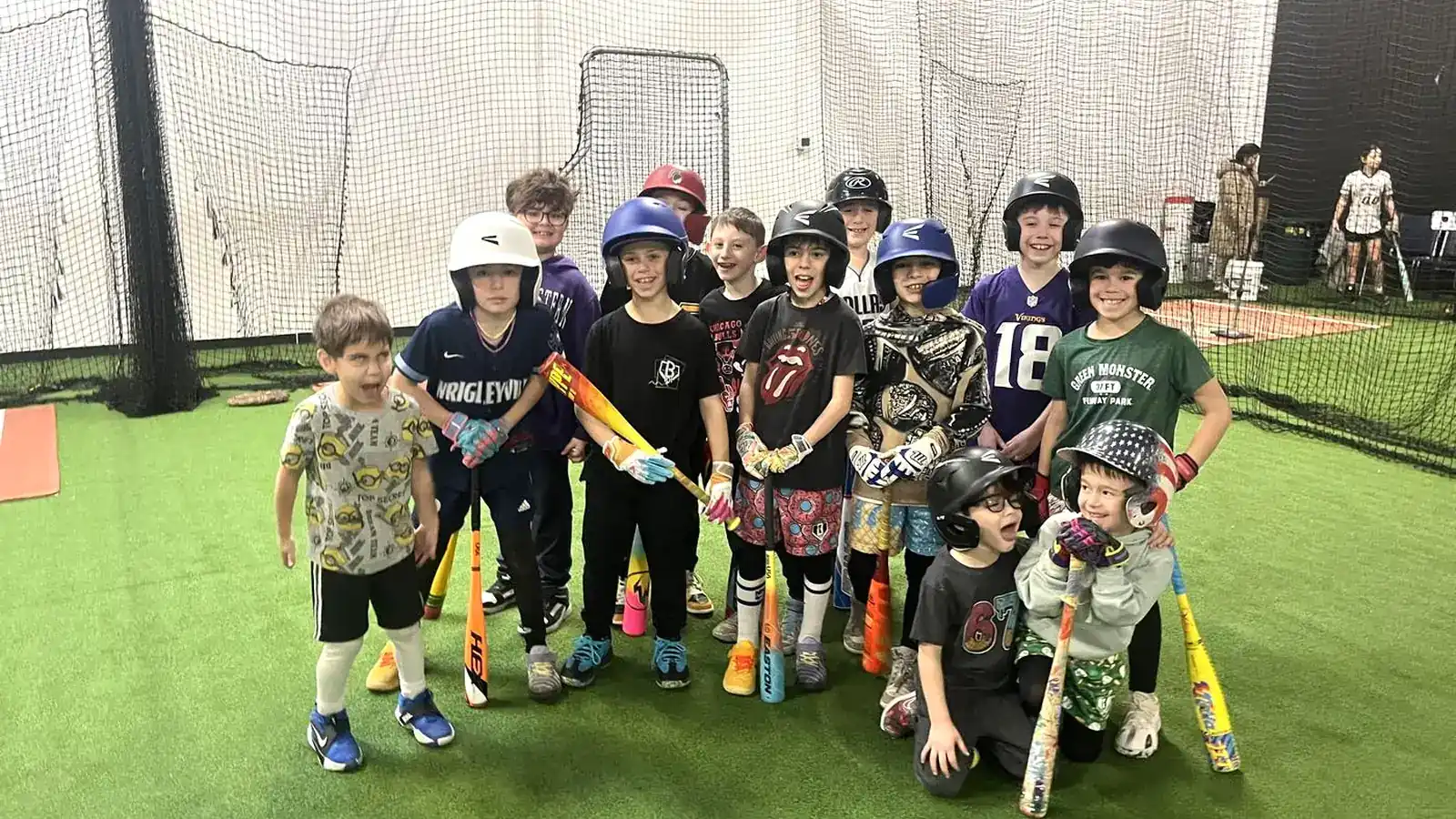Young players in helmets holding bats during an all-skills baseball class at the Gorilla facility